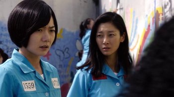 Movie still from “Sense8” (2015), directed by Tom Tykwer – Two young women in blue shirts standing next to each other; Close Up shot, Over the shoulder angle