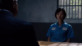 Movie still from “Sense8” (2015), directed by Tom Tykwer – A person sitting at a table in front of another person; Medium shot, Over the shoulder angle