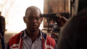 Movie still from “Sense8” (2015), directed by Tom Tykwer – A man is holding a gun up to his head; Close Up shot, Over the shoulder angle