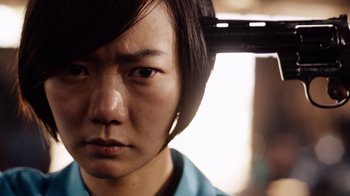 Movie still from “Sense8” (2015), directed by Tom Tykwer – A person with a hair dryer on their head; Close Up shot, Low angle