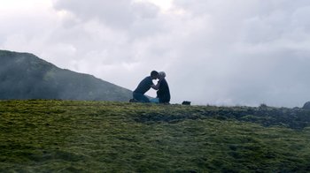 Movie still from “Sense8” (2015), directed by Tom Tykwer – Two people sitting on a hill with their heads together; Extreme Wide shot, Low angle
