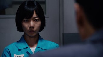 Movie still from “Sense8” (2015), directed by Tom Tykwer – A woman looking at a man in the mirror; Close Up shot, Over the shoulder angle