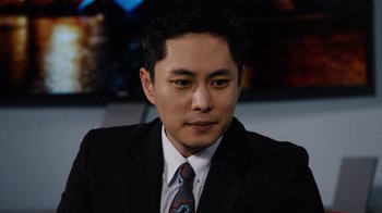 Movie still from “Sense8” (2015), directed by Tom Tykwer – A person wearing a suit and tie; Close Up shot, High angle