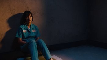 Movie still from “Sense8” (2015), directed by Tom Tykwer – A woman sitting on a bench in a room; Medium shot, High angle