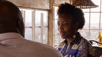 Movie still from “Sense8” (2015), directed by Tom Tykwer – A woman in a floral shirt talking to a man in a blue shirt; Close Up shot, Over the shoulder angle