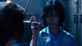 Movie still from “Sense8” (2015), directed by Tom Tykwer – A woman holding a cell phone in her hand; Close Up shot, High angle