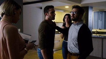 Movie still from “Sense8” (2015), directed by Tom Tykwer – Two men and a woman in a room; Medium shot, Over the shoulder angle