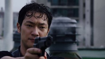 Movie still from “Sense8” (2015), directed by Tom Tykwer – A person holding a gun; Close Up shot, Low angle