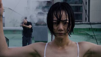 Movie still from “Sense8” (2015), directed by Tom Tykwer – A woman standing next to a man in a black shirt; Close Up shot, Low angle