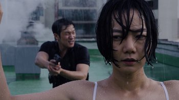 Movie still from “Sense8” (2015), directed by Tom Tykwer – A man and a woman in the water with a camera; Close Up shot, Over the shoulder angle