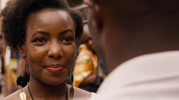 Movie still from “Sense8” (2015), directed by Tom Tykwer – A person wearing a necklace and a person wearing a white shirt; Close Up shot, Over the shoulder angle
