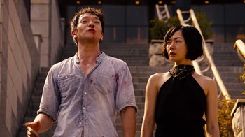 Movie still from “Sense8” (2015), directed by Tom Tykwer – A man and a woman standing next to each other; Medium shot, Low angle