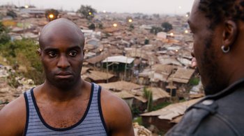 Movie still from “Sense8” (2015), directed by Tom Tykwer – A man standing next to another man on a hill; Close Up shot, Over the shoulder angle
