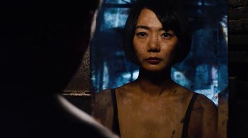 Movie still from “Sense8” (2015), directed by Tom Tykwer – A woman is standing in front of a mirror; Close Up shot, Over the shoulder angle