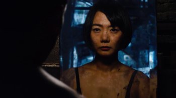 Movie still from “Sense8” (2015), directed by Tom Tykwer – A woman is looking at her reflection in a mirror; Close Up shot, Over the shoulder angle