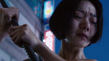 Movie still from “Sense8” (2015), directed by Tom Tykwer – A woman holding onto a metal bar in the dark; Close Up shot, Low angle