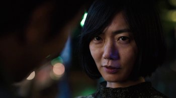 Movie still from “Sense8” (2015), directed by Tom Tykwer – A woman's face in the dark; Close Up shot, Over the shoulder angle