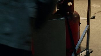 Movie still from “Sense8” (2015), directed by Tom Tykwer – A gas tank sitting on top of a table next to a fire hydrant; Extreme Close Up shot, High angle
