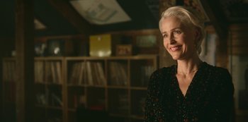 Movie still from “Sex Education” (2019), created by Laurie Nunn – A woman standing in front of a book shelf; Close Up shot, Over the shoulder angle