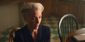Movie still from “Sex Education” (2019), created by Laurie Nunn – A woman sitting at a table in a kitchen; Close Up shot, Over the shoulder angle