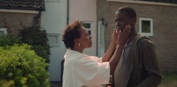 Movie still from “Sex Education” (2019), created by Laurie Nunn – A woman touching a man's face with her hands; Close Up shot, Over the shoulder angle