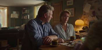 Movie still from “Sex Education” (2019), created by Laurie Nunn – A man and a woman sitting at a wooden table; Medium shot, Over the shoulder angle