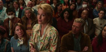 Movie still from “Sex Education” (2019), created by Laurie Nunn – A woman standing in front of a group of people; Medium shot, Over the shoulder angle