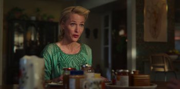 Movie still from “Sex Education” (2019), created by Laurie Nunn – A woman sitting at a dinner table looking at the camera; Close Up shot, Over the shoulder angle