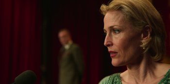 Movie still from “Sex Education” (2019), created by Laurie Nunn – A person wearing a suit and tie; Close Up shot, Over the shoulder angle
