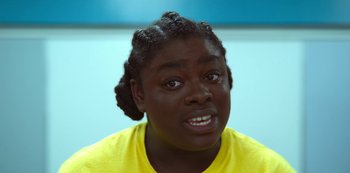 Movie still from “Sex Education” (2019), created by Laurie Nunn – A person with a yellow shirt is looking at the camera; Close Up shot, High angle