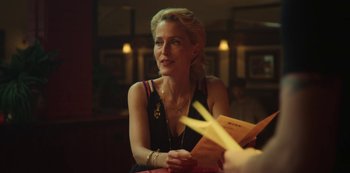 Movie still from “Sex Education” (2019), created by Laurie Nunn – A woman sitting at a table in front of a menu; Close Up shot, Over the shoulder angle