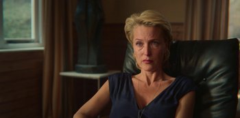 Movie still from “Sex Education” (2019), created by Laurie Nunn – A woman sitting in an office chair looking at the camera; Close Up shot, Over the shoulder angle