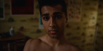 Movie still from “Sex Education” (2019), created by Laurie Nunn – A young man is looking into the camera; Close Up shot, Low angle