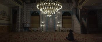 Movie still from “Mr. Robot” (2015), created by Sam Esmail – A person sitting on the ground in front of a chandelier; Extreme Wide shot, Low angle