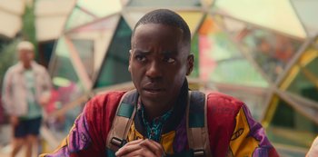 Movie still from “Sex Education” (2019), created by Laurie Nunn – A person wearing a colorful shirt; Close Up shot, Over the shoulder angle