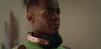 Movie still from “Sex Education” (2019), created by Laurie Nunn – A person wearing headphones; Close Up shot, Over the shoulder angle