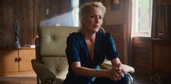 Movie still from “Sex Education” (2019), created by Laurie Nunn – A woman sitting in a chair with her hands crossed; Medium shot, Over the shoulder angle