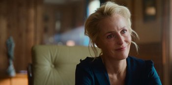 Movie still from “Sex Education” (2019), created by Laurie Nunn – A person sitting on a couch; Close Up shot, Over the shoulder angle