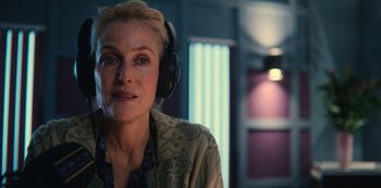 Movie still from “Sex Education” (2019), created by Laurie Nunn – A woman wearing headphones and looking at the camera; Close Up shot, Over the shoulder angle