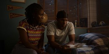 Movie still from “Sex Education” (2019), created by Laurie Nunn – A man and a woman sitting on a bed playing a video game; Medium shot, Over the shoulder angle