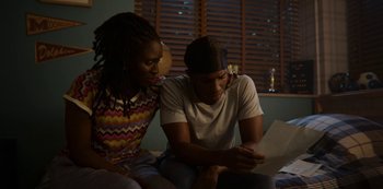 Movie still from “Sex Education” (2019), created by Laurie Nunn – A man and a woman looking at a piece of paper; Medium shot, High angle