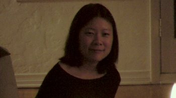 Movie still from “Shirkers” (2018), directed by Sandi Tan – A woman in a black shirt is smiling for the camera; Medium shot, High angle