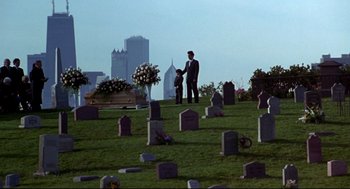 Movie still from “Sleepless in Seattle” (1993), directed by Nora Ephron – A man and a child standing in front of a grave in a cemetery; Extreme Wide shot, High angle