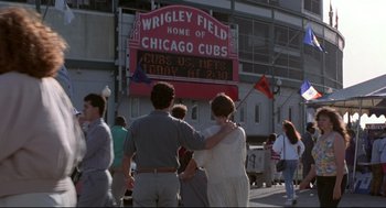 Movie still from “Sleepless in Seattle” (1993), directed by Nora Ephron – A couple of people that are standing in front of a building; Wide shot, Over the shoulder angle