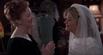 Movie still from “Sleepless in Seattle” (1993), directed by Nora Ephron – Two women are talking to each other in a room; Close Up shot, Over the shoulder angle