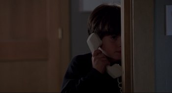 Movie still from “Sleepless in Seattle” (1993), directed by Nora Ephron – A young boy holding a phone to his ear; Close Up shot, High angle