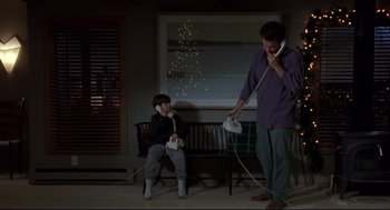 Movie still from “Sleepless in Seattle” (1993), directed by Nora Ephron – A man and a child playing a video game; Wide shot, Low angle