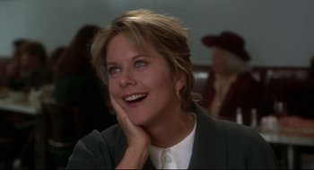 Movie still from “Sleepless in Seattle” (1993), directed by Nora Ephron – A person smiling with her hand on her face; Close Up shot, Over the shoulder angle