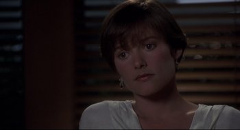 Movie still from “Sleepless in Seattle” (1993), directed by Nora Ephron – A person with short brown hair; Close Up shot, Over the shoulder angle