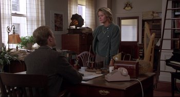 Movie still from “Sleepless in Seattle” (1993), directed by Nora Ephron – A woman standing at a table talking to a man; Medium shot, Over the shoulder angle